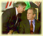 Andrew Card whispers something to President Bush after the second planes strikes the WTC