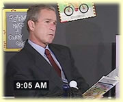 Bush reads on to the kids with the World Trade Center burns